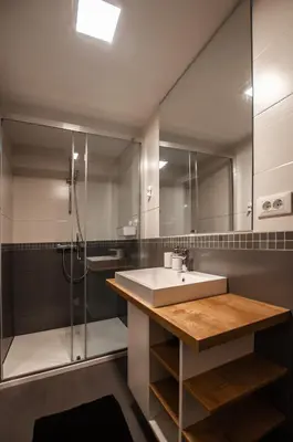 a bathroom with a sink and a shower at Cozy Little Apartments in Ig