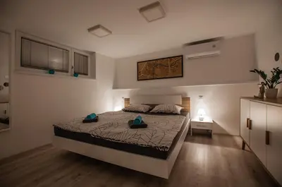 a bedroom with a large bed in a room at Cozy Little Apartments in Ig