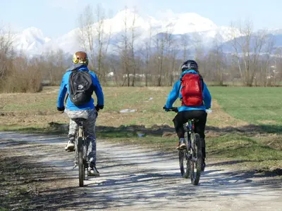 two people riding bikes down a dirt road at House 1797 - Charm of Slovenian Vintage in Dob