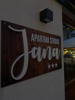 a sign on the side of a building at Apartma Studio Jana in Kranjska Gora