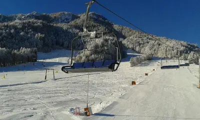 a ski lift going up a snow covered mountain at Apartma Studio Jana in Kranjska Gora