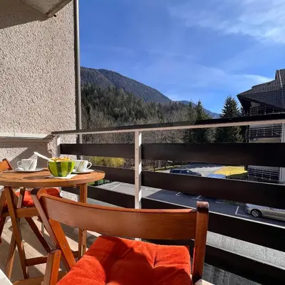 a table and chairs on a balcony with a view at Studio Mila in Kranjska Gora