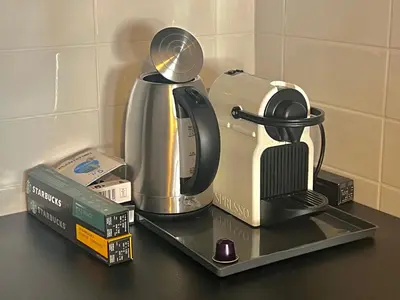 a counter top with a coffee maker and a tea kettle at Studio Mila in Kranjska Gora