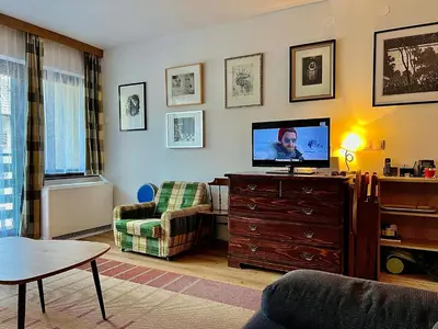 a living room with a flat screen tv on a dresser at Studio Mila in Kranjska Gora