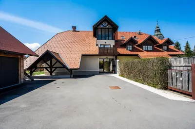 a large house with a driveway in front of it at GrosAlp apartments in Lesce