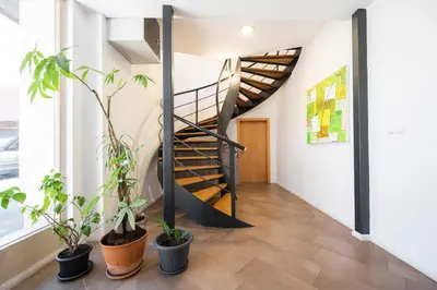 a spiral staircase in a room with potted plants at GrosAlp apartments in Lesce