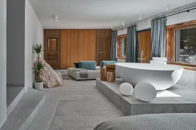 a bathroom with a large tub in the middle of a room at Milka Boutique Hotel in Kranjska Gora