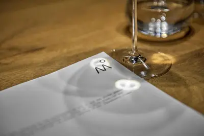 a paper with a smiley face drawn on it next to a glass at Milka Boutique Hotel in Kranjska Gora