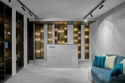 a lobby with a blue couch in a room at Milka Boutique Hotel in Kranjska Gora