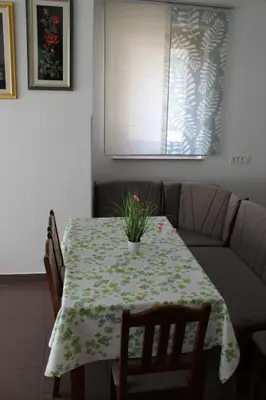 a dining room table with a plant on it at Apartma V&T in Bovec
