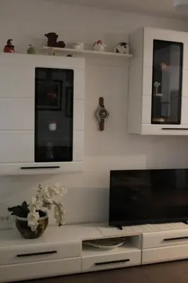 a living room with a flat screen tv and a tv stand at Apartma V&T in Bovec
