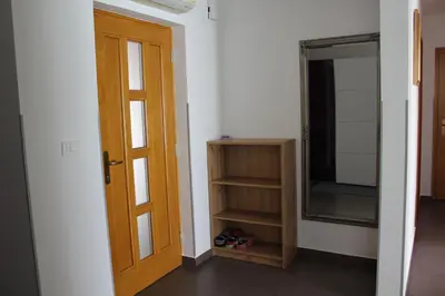 a room with a door and a mirror and some shoes at Apartma V&T in Bovec
