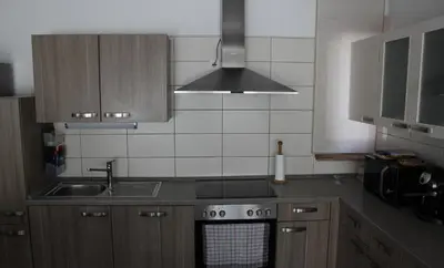 a kitchen with a sink and a stove top oven at Apartma V&T in Bovec