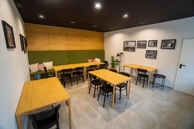 a restaurant with tables and chairs in a room at Hiša Pep's in Ivanjkovci