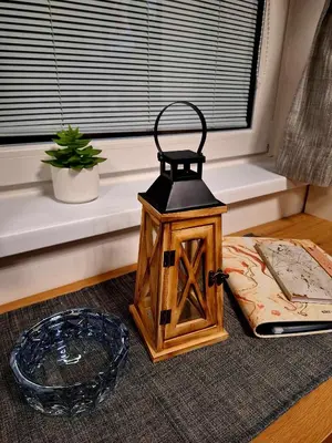 a lantern sitting on a table next to a window at Cherry House in Čatež ob Savi