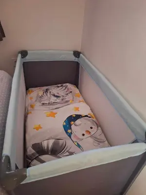 a crib with a hello kitty blanket in it at Cherry House in Čatež ob Savi