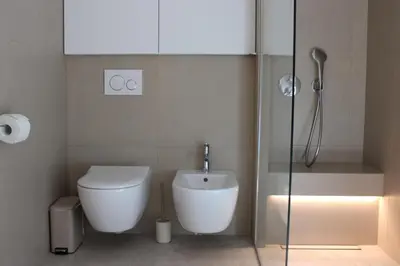 a bathroom with a toilet and a glass shower at Panoramic Forest Chalet Bled Lake and Castle View in Bled