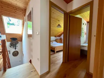 a room with a door leading to a bedroom at Panoramic Forest Chalet Bled Lake and Castle View in Bled