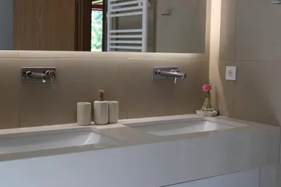 a bathroom with a white sink and a mirror at Panoramic Forest Chalet Bled Lake and Castle View in Bled