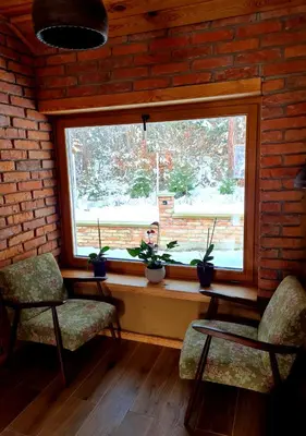 a room with two chairs and a window with plants at Turistična kmetija Hiša ob gozdu pri Ptuju in Ptuj