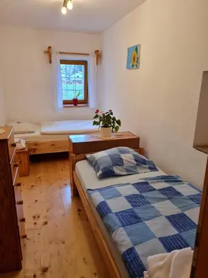 a bedroom with a bed and a desk and a window at Turistična kmetija Hiša ob gozdu pri Ptuju in Ptuj