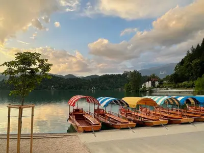 a group of boats are docked on a lake at Pleasant Apartments in Bled