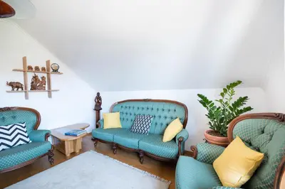 a living room with three chairs and a table at Pleasant Apartments in Bled