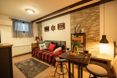 a living room with a couch and a table at Pleasant Apartments in Bled