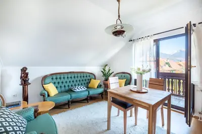 a living room with a couch and a table at Pleasant Apartments in Bled