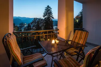 a balcony with a table and chairs with a view at DREAM BLED Balcony Apartment in Bled