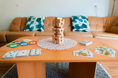 a coffee table with a wooden chess set on it at DREAM BLED Balcony Apartment in Bled