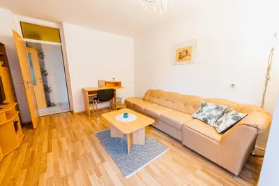 a living room with a couch and a table at DREAM BLED Balcony Apartment in Bled