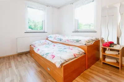 a bedroom with two bunk beds and two windows at DREAM BLED Balcony Apartment in Bled
