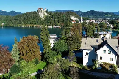 an aerial view of a house next to a lake at DREAM BLED Balcony Apartment in Bled
