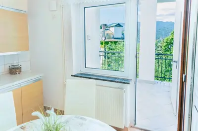 a kitchen with a door leading to a balcony at DREAM BLED Balcony Apartment in Bled