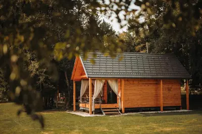 a log cabin with a black roof at Ranč Mackadam Ranch Mackadam in Tržič