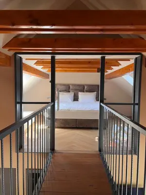a room with a bed in a loft with a staircase at Ranč Mackadam Ranch Mackadam in Tržič