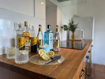 a counter with bottles of alcohol and lemons on it at Alpine Retreat - Lake Bled in Bled