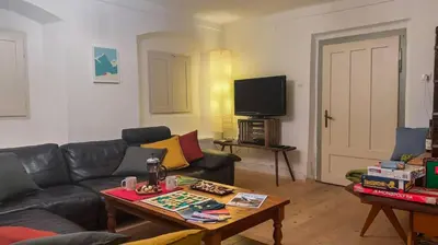 a living room with a couch and a table at Alpine Retreat - Lake Bled in Bled