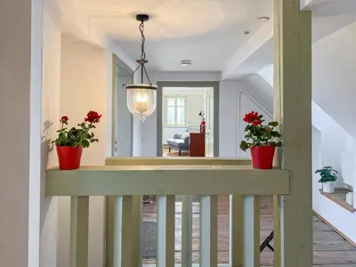 a hallway with two potted plants on a railing at Alpine Retreat - Lake Bled in Bled