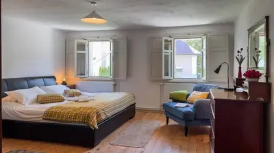 a bedroom with a bed and a desk and a chair at Alpine Retreat - Lake Bled in Bled