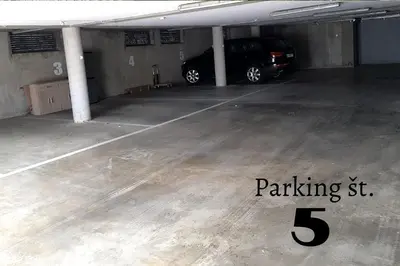 a parking garage with a car parked in it at Family apartment Moravske Toplice in Moravske Toplice