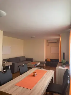 a living room with a table and a couch at Apartma Moravske Toplice 16 in Moravske Toplice