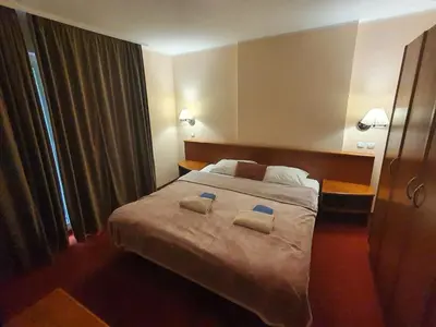 a bedroom with a large bed with two towels on it at Aparthotel Rosa - apartma 204 in Podčetrtek