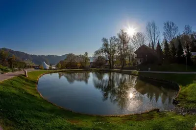 a small pond in the middle of a park at Aparthotel Rosa - apartma 204 in Podčetrtek