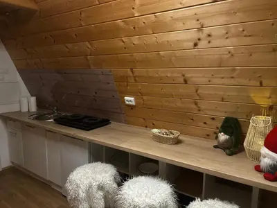 a kitchen with a counter with two white fuzzyools at NEW! Glamping House with new hot tub and sauna- Hisa oddiha UPDATED DECEMBER 2025 in Smarjeske Toplice