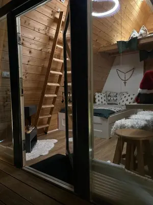 a small room with a staircase and a bed at NEW! Glamping House with new hot tub and sauna- Hisa oddiha UPDATED DECEMBER 2025 in Smarjeske Toplice
