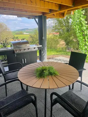 a table and chairs on a patio with a grill at NEW! Glamping House with new hot tub and sauna- Hisa oddiha UPDATED DECEMBER 2025 in Smarjeske Toplice