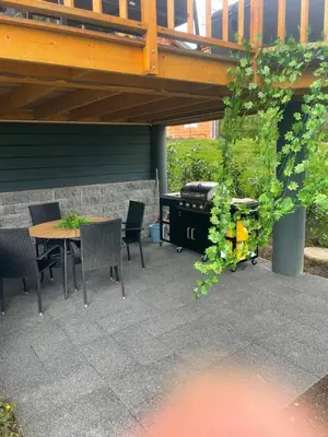 a patio with a table and chairs and a grill at NEW! Glamping House with new hot tub and sauna- Hisa oddiha UPDATED DECEMBER 2025 in Smarjeske Toplice