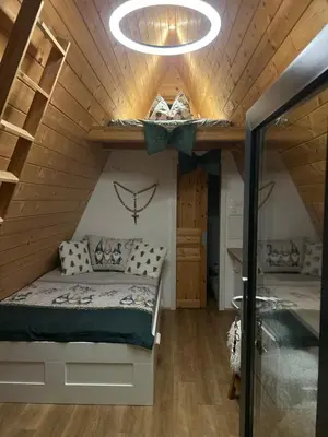 a bedroom in a tiny house with a bed at NEW! Glamping House with new hot tub and sauna- Hisa oddiha UPDATED DECEMBER 2025 in Smarjeske Toplice